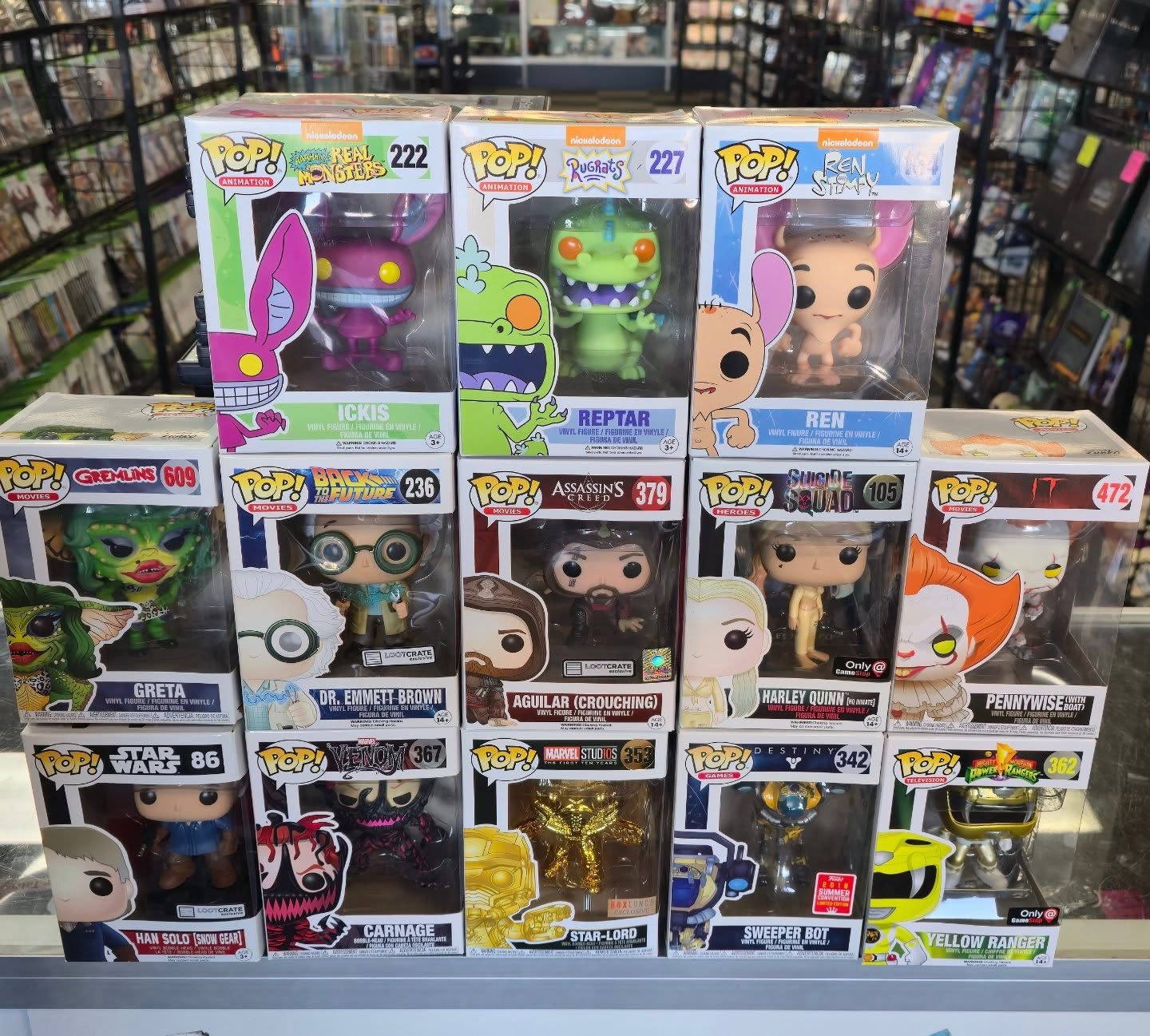 Funko POP! figures including Rugrats Reptar, Powerpuff Girls, and more on display